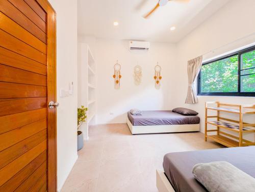 a bedroom with a bed and a window at v27 Sunset Horizon Villa Seaview in Haad Yao