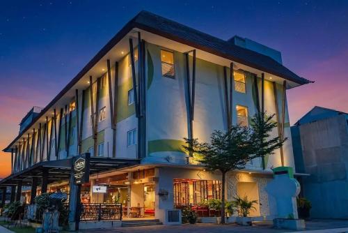 a large building with a lot of windows at night at Palette Legian Beach in Legian