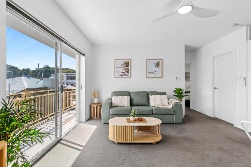 a living room with a couch and a table at Ocean Spray 5 in Coffs Harbour