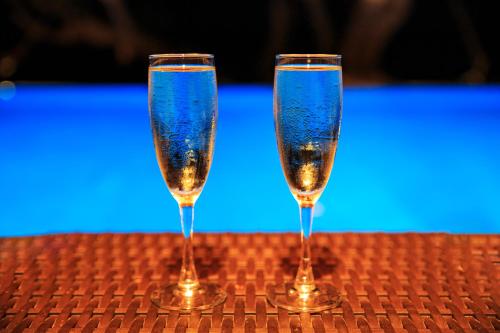 two glasses of champagne sitting on a table at Maui Palms in Korolevu