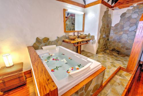 a bathroom with a bath tub in a house at Maui Palms in Korolevu