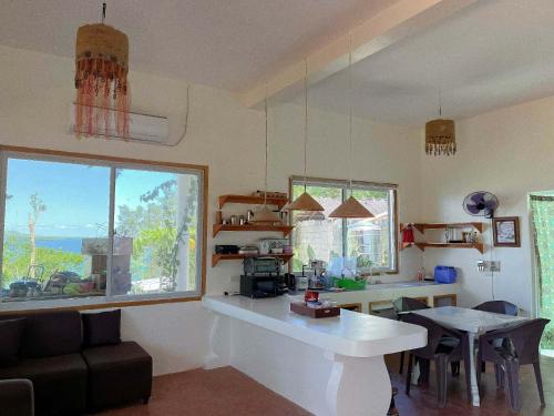 a kitchen and dining room with a table and a window at Durano Seaside Retreat in Mercedes