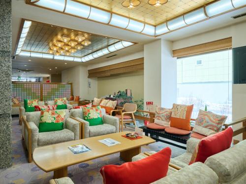 a waiting room with couches and chairs and a table at Oyado Kiyomizuya in Noboribetsu