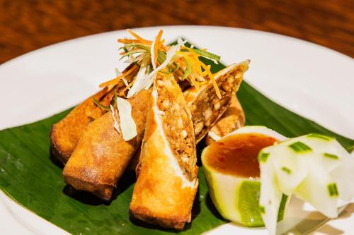 a plate of food with bread and toast on a banana leaf at Maui Palms in Korolevu