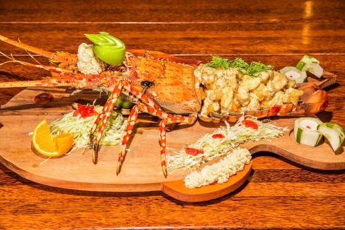 a plate of food with seafood on a wooden board at Maui Palms in Korolevu