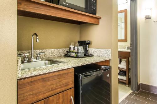 a small kitchen with a sink and a microwave at Comfort Suites Effingham Central in Effingham
