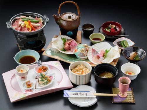 a table topped with plates and bowls of food at Oyado Kiyomizuya in Noboribetsu