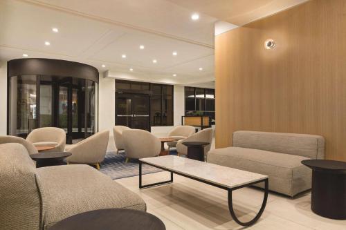 a waiting room with couches and chairs and a table at Radisson Hotel Seattle Airport in SeaTac