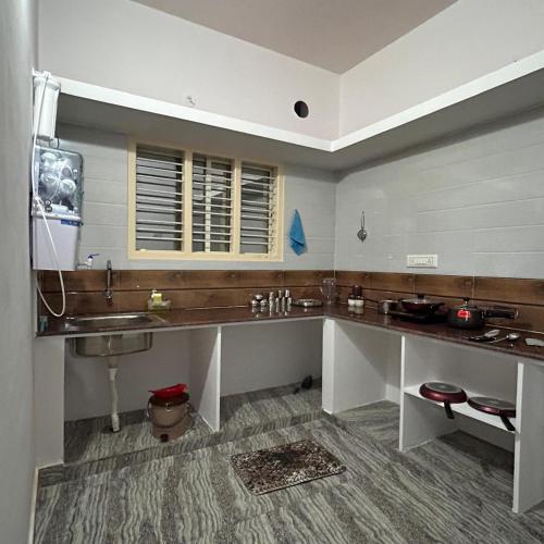 a large bathroom with a sink and a sink at Simba Stay's 2BHK in Chikmagalūr