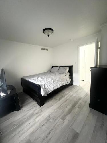 a bedroom with a bed and a wooden floor at Renovated Downtown Phoenix Condo in Phoenix
