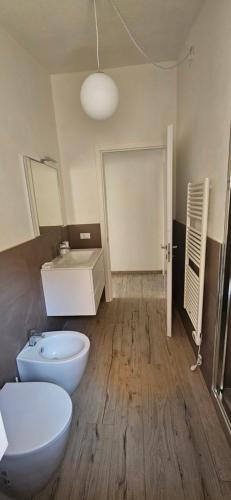 a bathroom with a white toilet and a sink at Blue Living -Archi di Mare in Marciana Marina