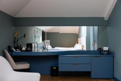 a room with a blue counter with a bed in the background at Lion's Castle Hotel in Lviv