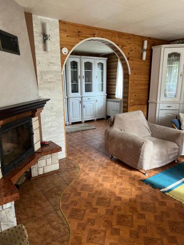 a living room with a couch and a fireplace at UKRYTY SKARB in Głobikówka