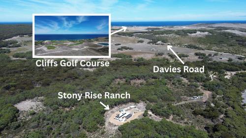 an aerial view of a golf course and a house at Stony Rise Ranch in Pelican Lagoon