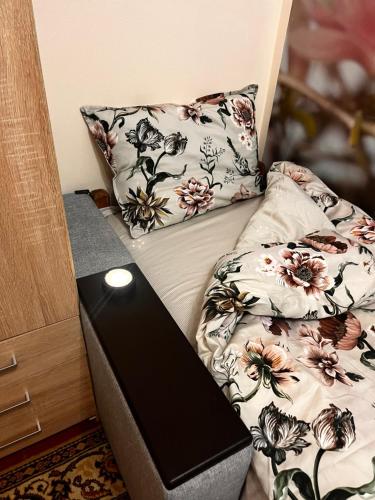 a bed with a pillow and a laptop on it at City Relax 2 in Bălţi
