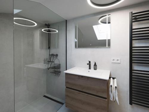 a bathroom with a white sink and a shower at Holiday home with panoramic views in Tulfes