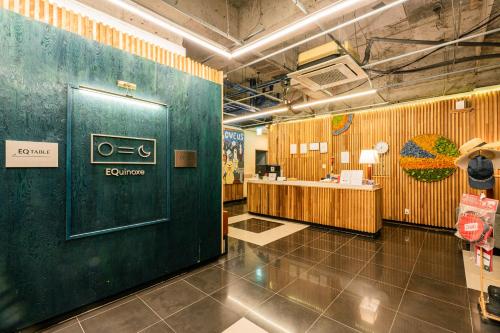 a bathroom with a green door in a room at Jeju EQ Stay Hotel in Jeju