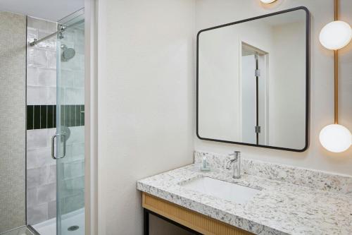 a bathroom with a sink and a shower at Courtyard Virginia Beach Norfolk in Virginia Beach