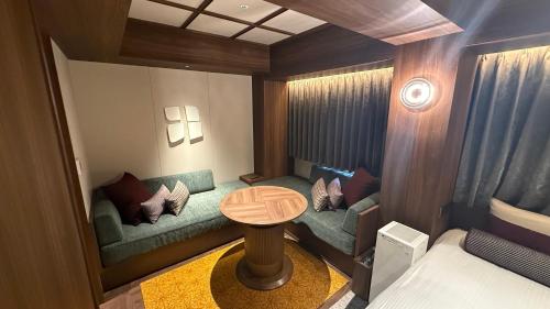 a small room with a couch and a table at Hotel Keihan Asakusa in Tokyo