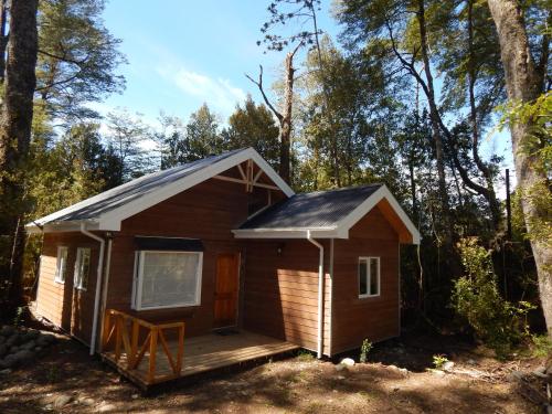 a small cabin in the woods with trees at Cabañas Nutrias Patagonicas in Puelo