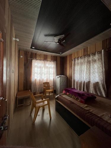 a room with a bed and a chair in it at Peace Forest Retreat in Gopeshwar