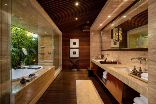 a bathroom with two sinks and a bath tub at Ametis Villa Bali in Canggu