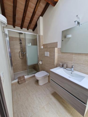 a bathroom with a shower and a toilet and a sink at Casa Lori in Fauglia