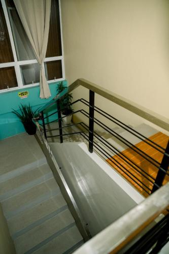 a staircase in a building with a stair railing at CELCOR PENSION HOUSE in Cabatuan