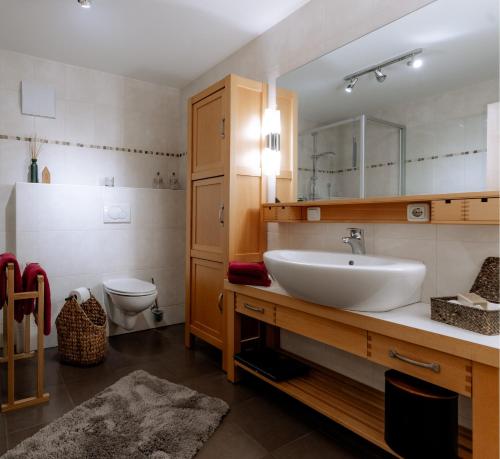 a bathroom with a sink and a toilet at Watzmann-Appartement in Ramsau