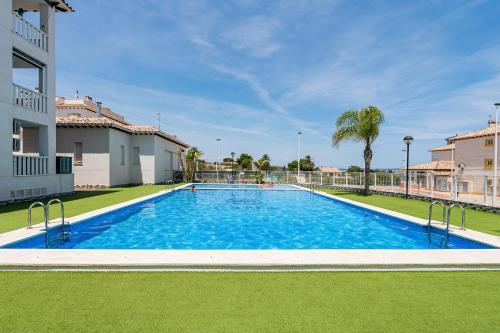 a large swimming pool in the middle of a yard at Playa del Pinet 2 in La Marina