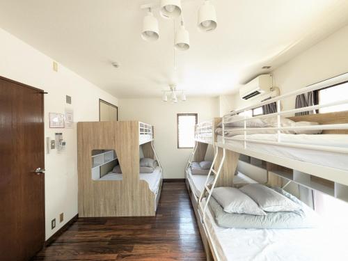 a room with two bunk beds in it at en stay001 in Osaka