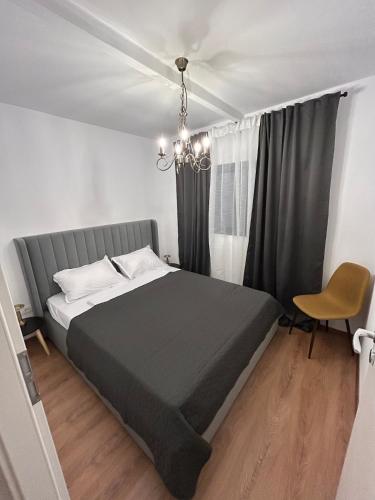 a bedroom with a large bed and a window at Tiny Cozia Caciulata in Caciulata
