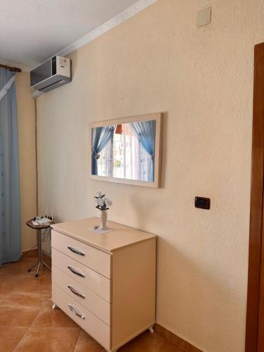 a bathroom with a sink and a dresser at Double Triple Rooms With Lake View balcony in Pogradec