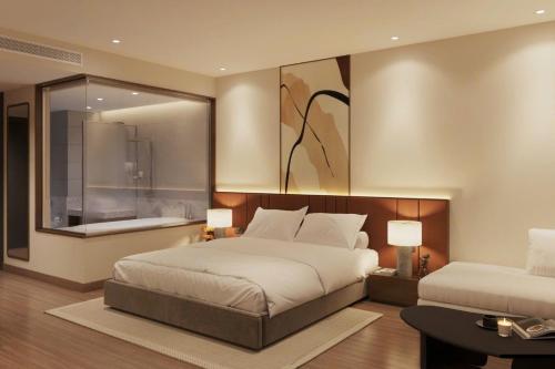 a bedroom with a large bed and a large window at D'Celes Hotel in Làng Tiên Cát