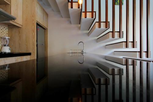 a stairway with a faucet in the middle at The Murdha Villa in Seminyak