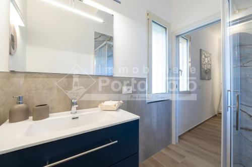 a bathroom with a white sink and a shower at Raphael's Boutique Stay in Palau
