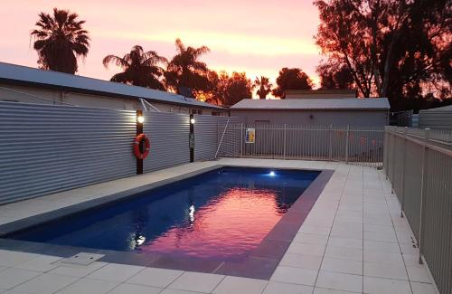 a swimming pool in the backyard of a house at Comfort Inn & Suites Augusta Westside in Port Augusta