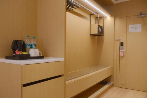 a room with a kitchen with a counter and a cupboard at Metta Shaanti Hotel Shravasti in Khargupur