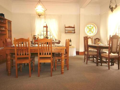 a dining room with a wooden table and chairs at Belle Vue in Queenstown