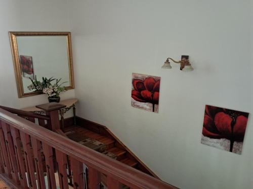 a staircase with three pictures on the wall and a mirror at Belle Vue in Queenstown