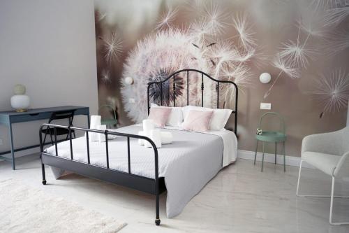 a bedroom with a bed and a table and a chair at Luxury Suite ATHENA - MINERVA in Reggio di Calabria