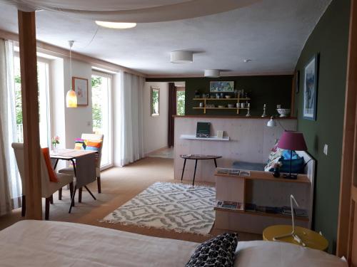 a bedroom with a bed and a dining room with a table at Südalpen Lofts in Bleiburg