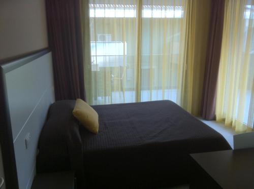 a bedroom with a bed and a large window at Residence Ormeggio in Grado