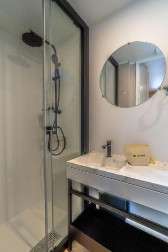 a bathroom with a sink and a mirror at Club del Sole Val di Fiemme Easy Camping Village in Bellamonte