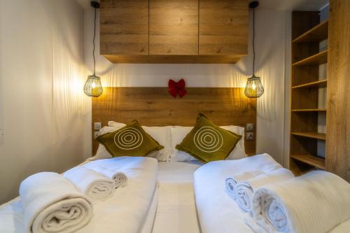 a bedroom with a bed with white sheets and pillows at Club del Sole Val di Fiemme Easy Camping Village in Bellamonte