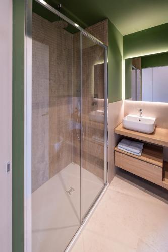 a glass shower in a bathroom with a sink at G Palace Residence in Civitanova Marche