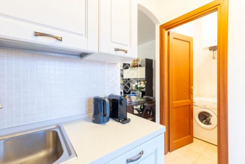 a kitchen with a sink and a counter top at Villino Joy in Stintino