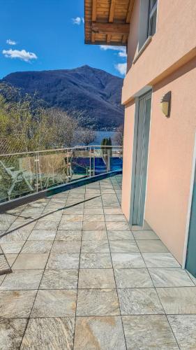 a balcony of a building with mountains in the background at Casa Belfiore in Maccagno Superiore