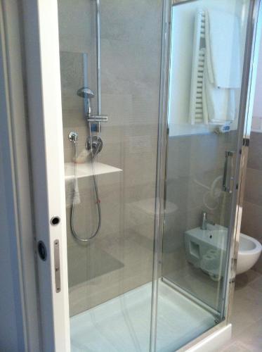 a shower with a glass door in a bathroom at Residence Ormeggio in Grado