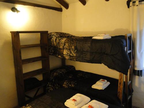 a room with two bunk beds and a ladder at Cabañas Terramaría de Potrerillos in Potrerillos